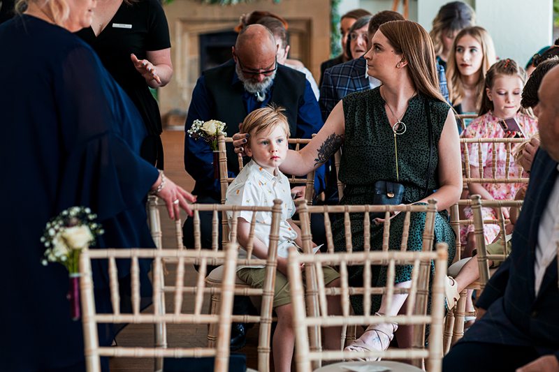 People seated at a wedding ceremony.