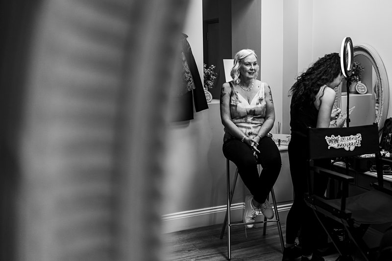 Woman getting ready with make-up artist in studio.