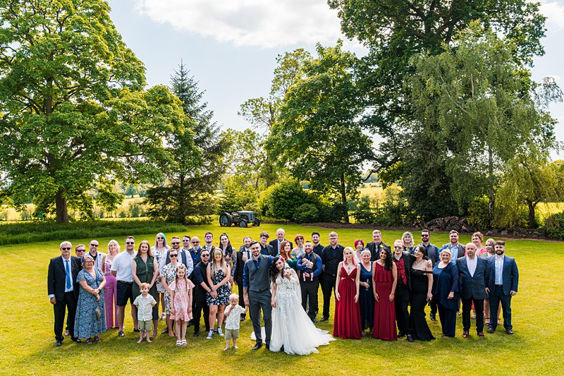 Wedding group photo in a garden.