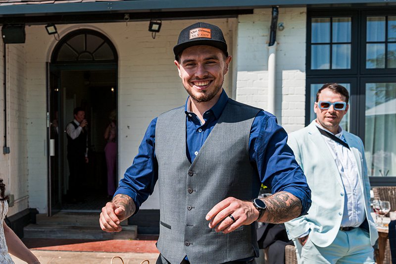 Man smiling at an outdoor event.