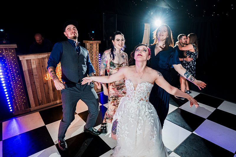 Bride and wedding guests dancing on the dance floor.