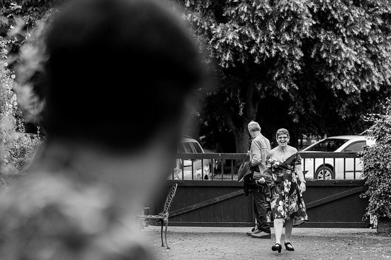 Woman in floral dress walking outside.