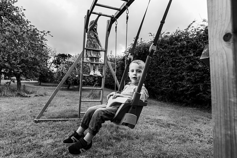 Children playing on swings in a park.