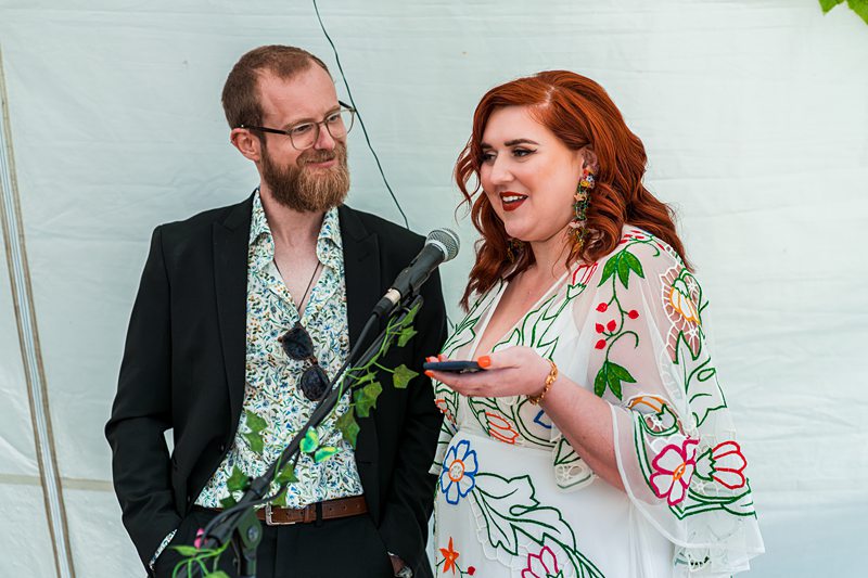 Two people speaking at an event.