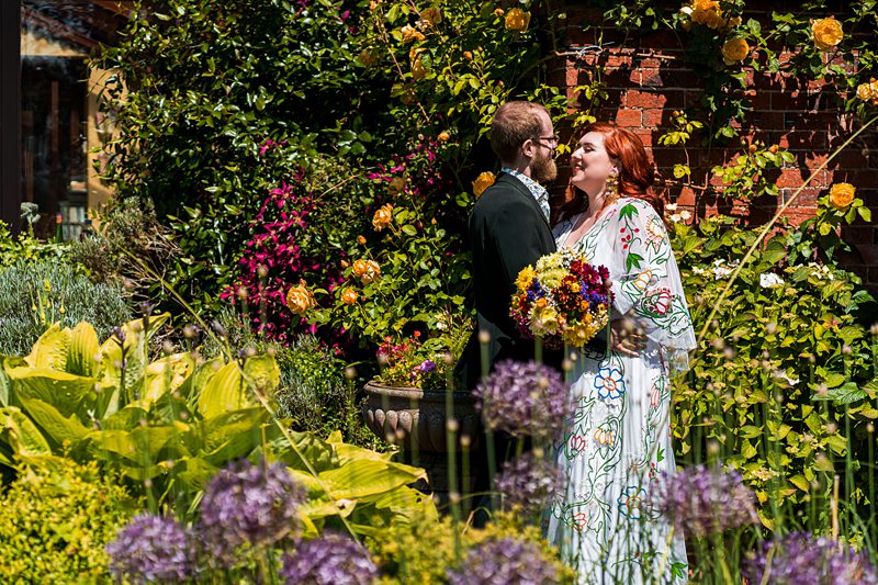Couple smiling in a colourful garden