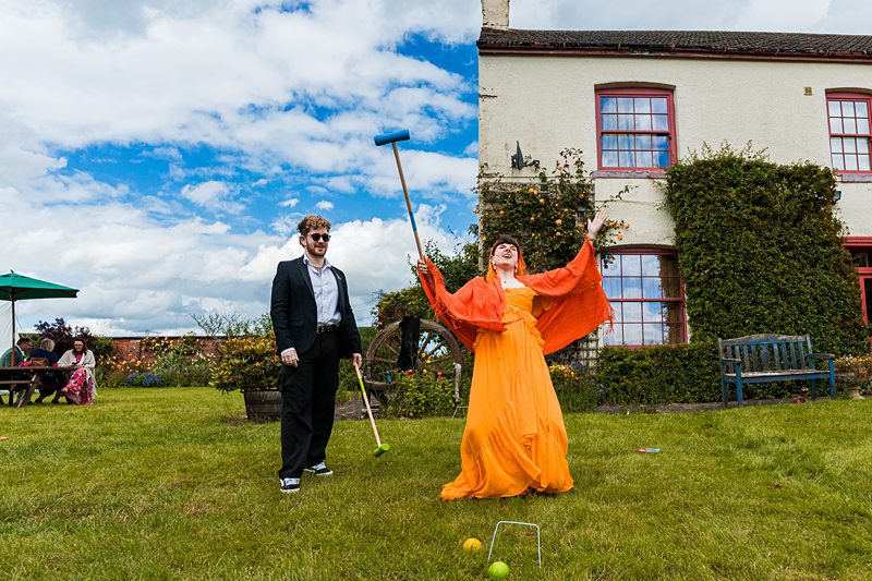 People playing croquet in a garden.