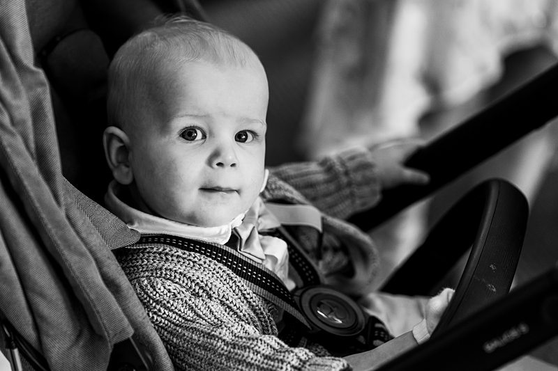 Black and white photo of baby in pram.