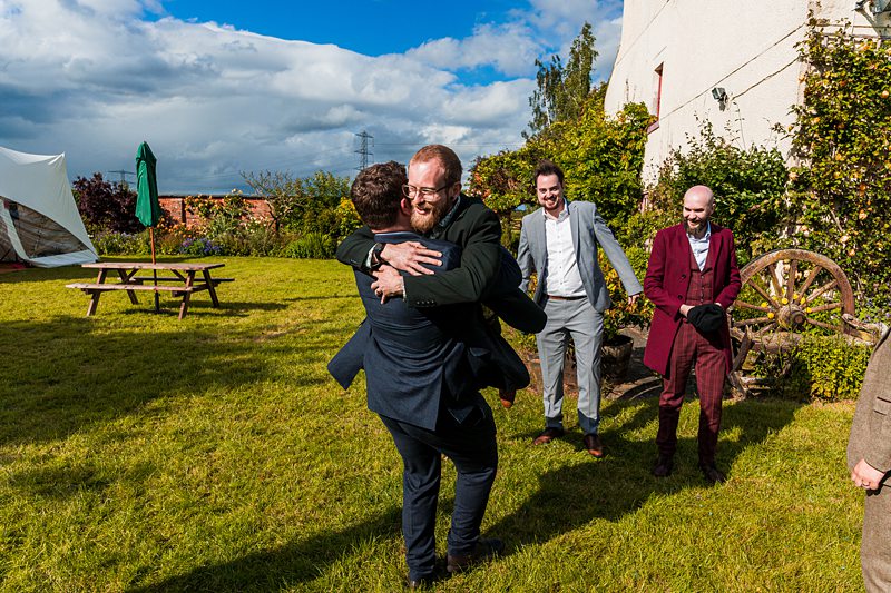 Men hugging at an outdoor event