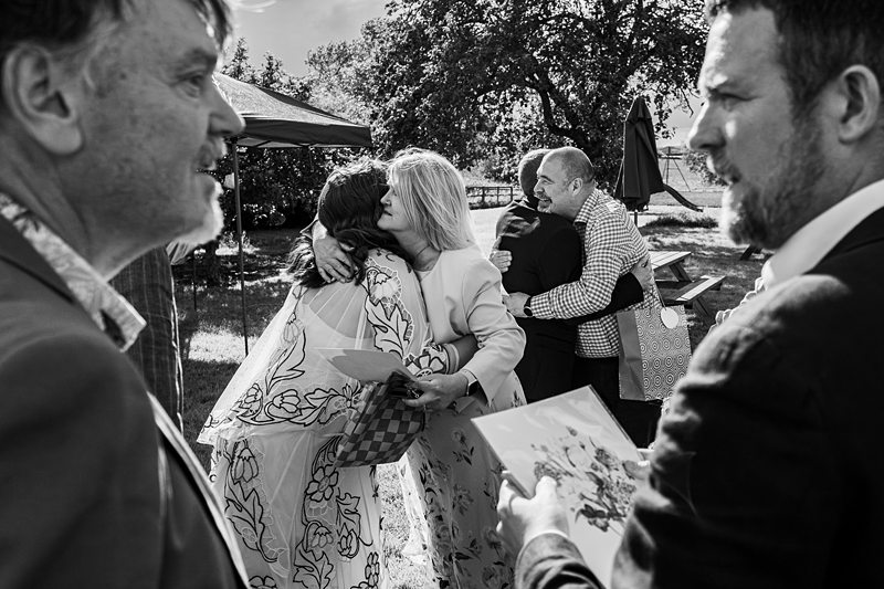 People hugging at outdoor event.