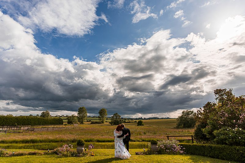 Couple embracing in picturesque countryside landscape