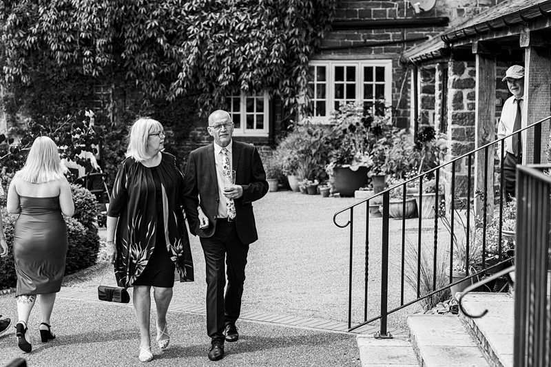 Guests walking at an outdoor wedding venue.