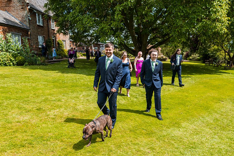 Groom with guests at outdoor wedding