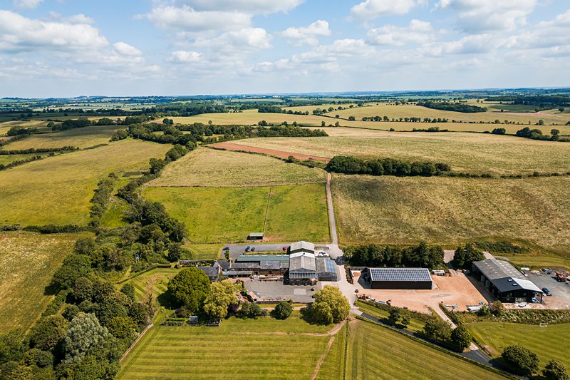 Aerial view of large farm and fields.