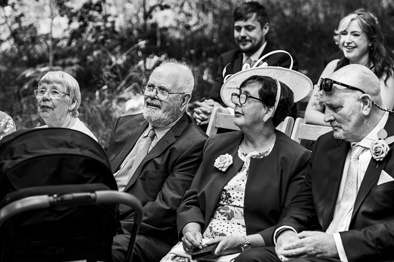 Guests seated at an outdoor wedding ceremony