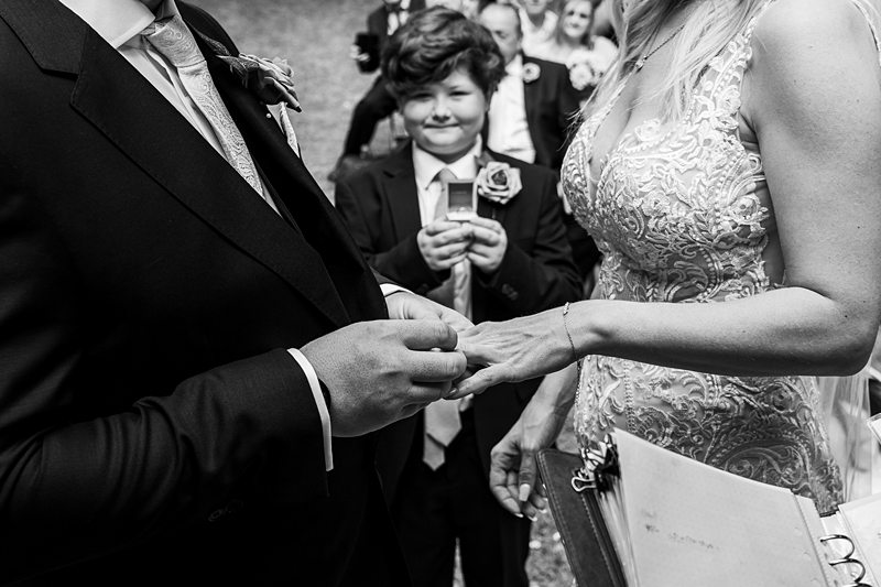 Bride and groom exchanging wedding rings.