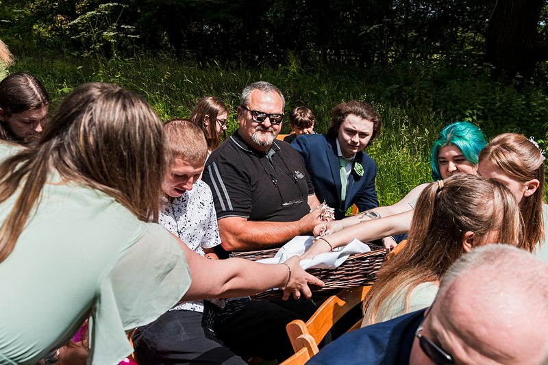 People at an outdoor gathering, sunny day.