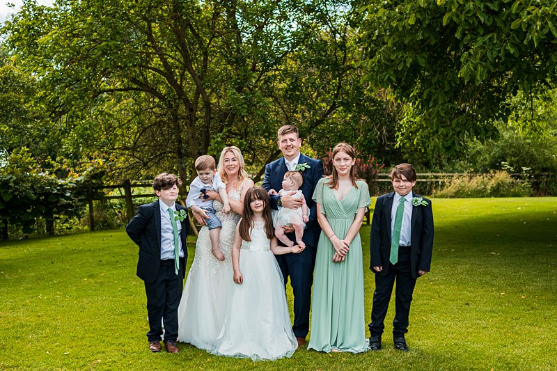Family wedding photo in garden.