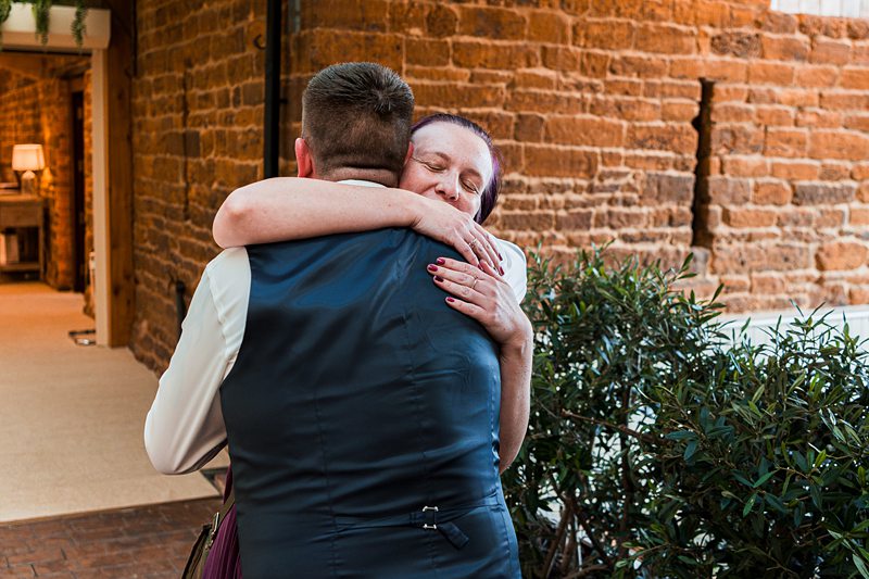 People warmly hugging each other outdoors