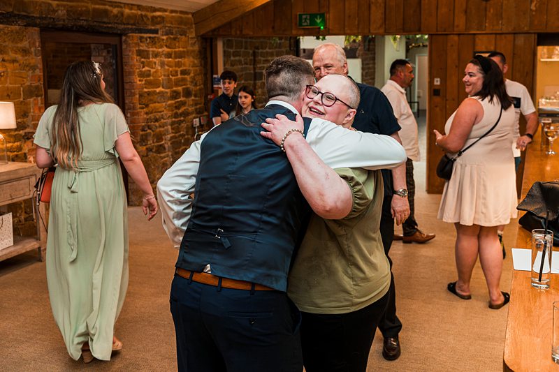 People hugging at a social event.