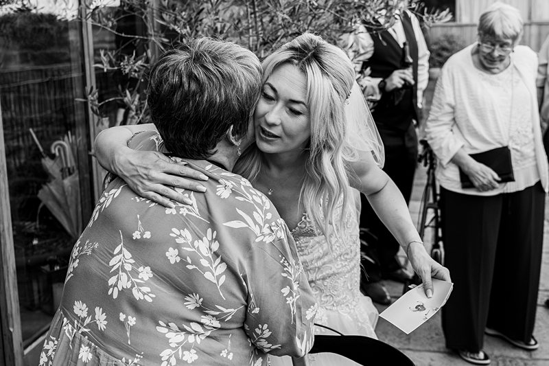 Bride hugs guest at wedding