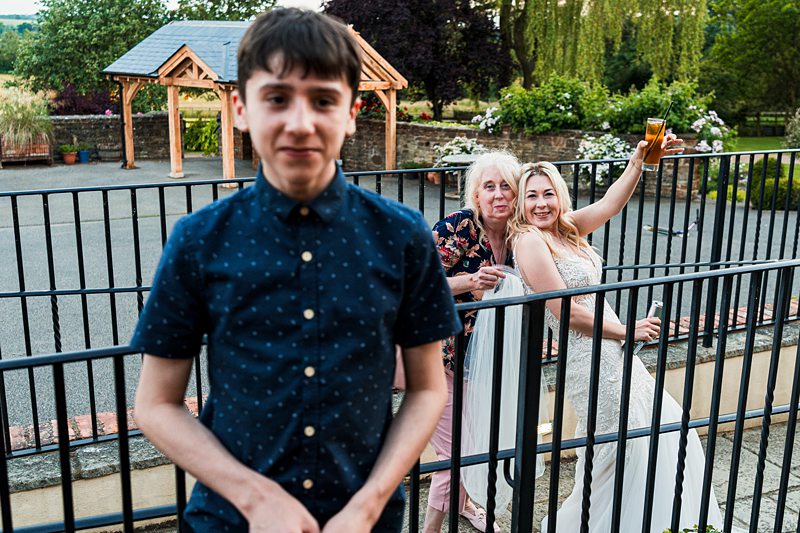 Boy at wedding with celebrating guests.