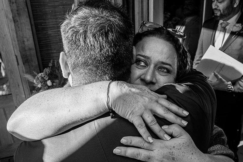 Emotional hug between two people at event.