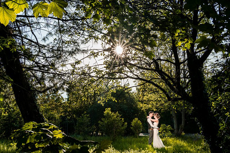 Couple embracing in a sunlit forest clearing
