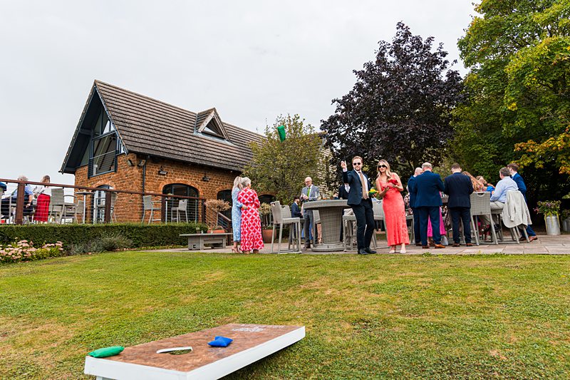 Garden party at countryside house with guests.