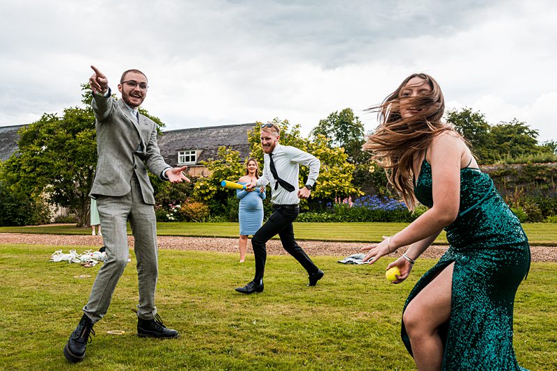 People playing ball game on grass during event.