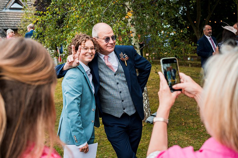 Two people posing at a garden event.