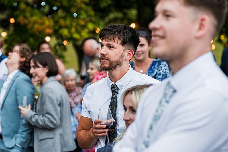 Guests enjoying an outdoor wedding celebration.