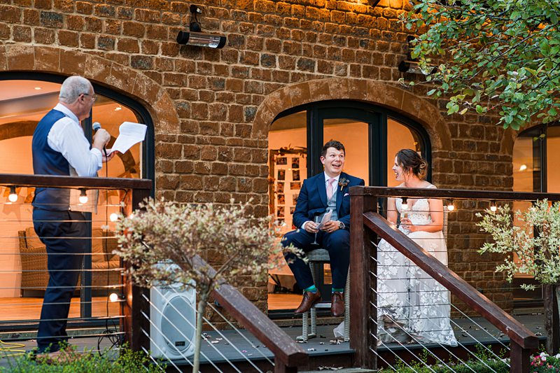 Wedding speech on terrace with bride and groom.