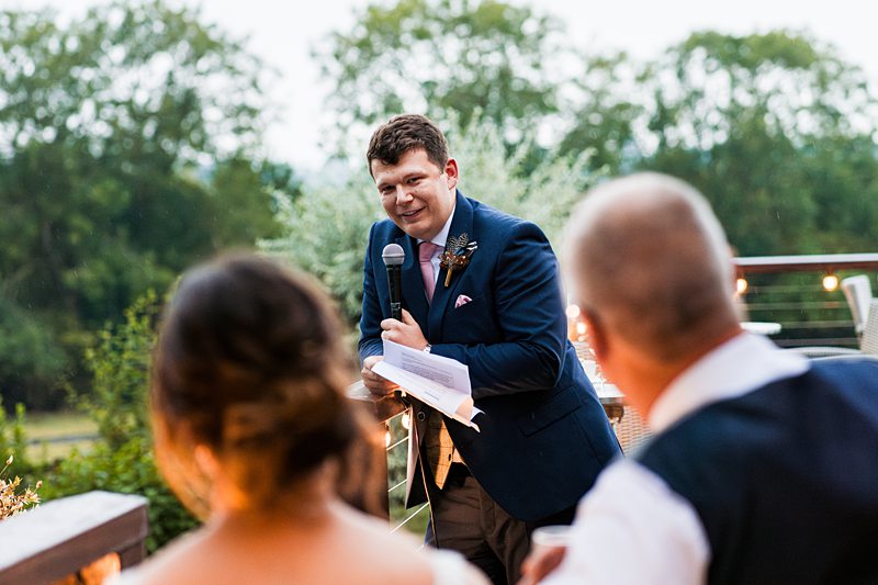 Man giving speech outdoors with microphone