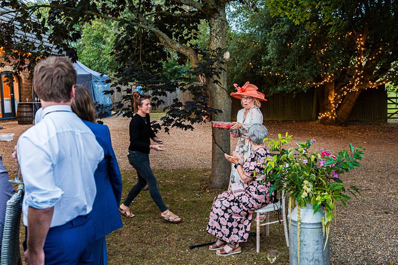 Garden party with people socialising outdoors.