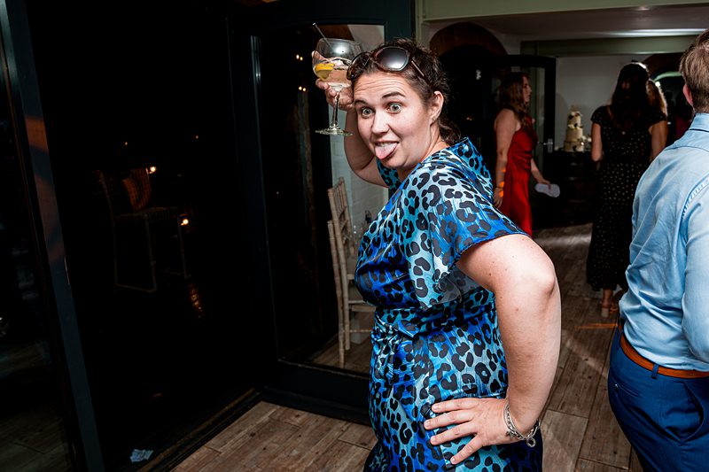 Woman in blue dress having fun at party.