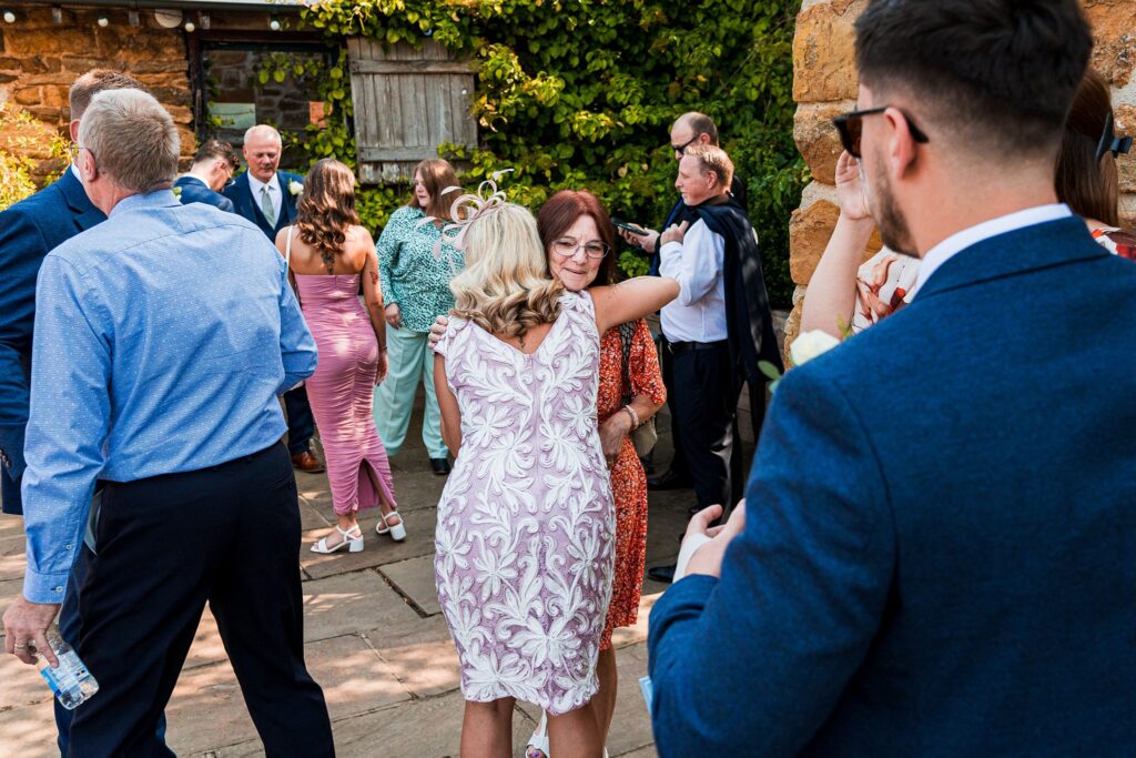 Guests mingling at an outdoor wedding celebration.