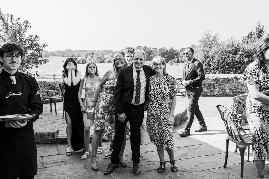 Smiling group at outdoor event, stylishly dressed.