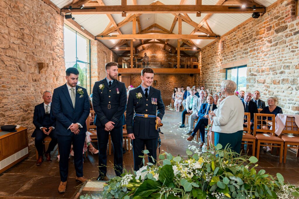 Wedding ceremony in rustic stone hall with guests.