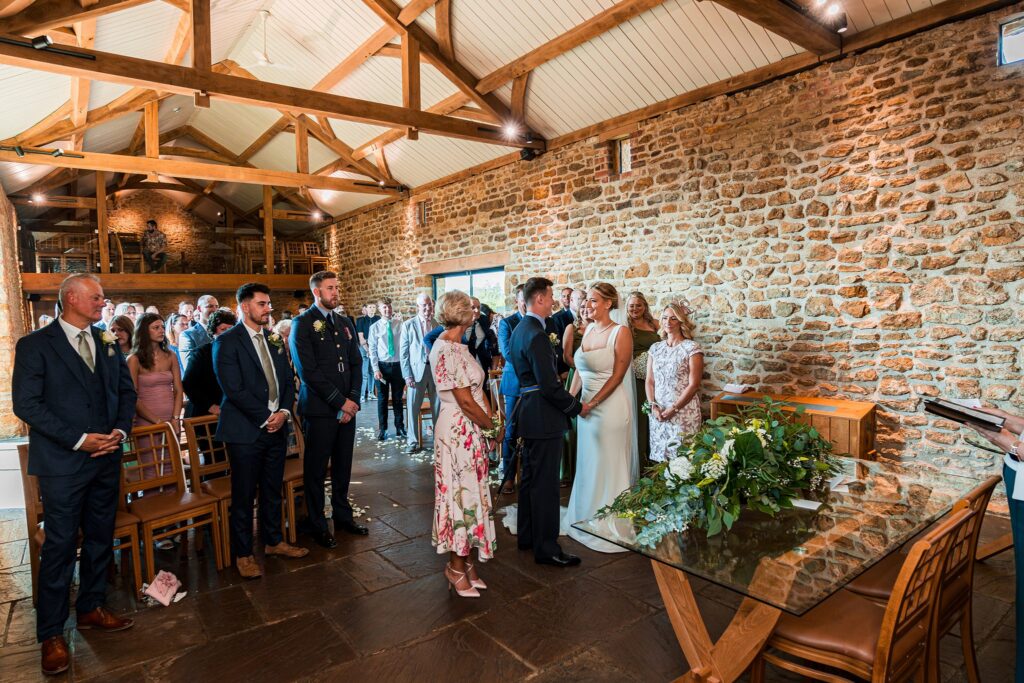 Wedding ceremony in rustic barn setting.