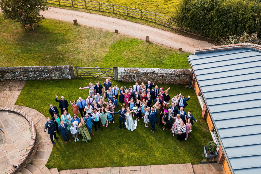 Aerial view of a large wedding group outdoors.