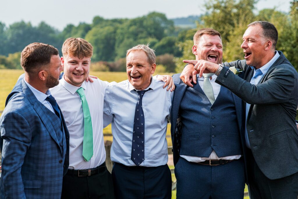 Group of men laughing in outdoor setting
