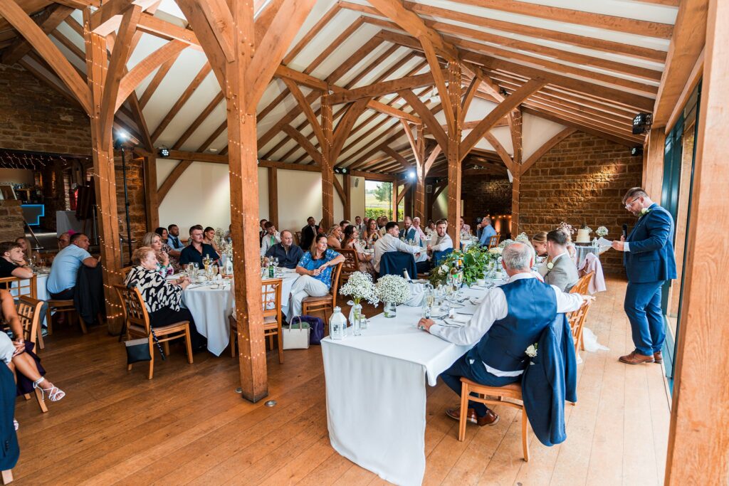 Guests seated at a traditional wedding reception venue.