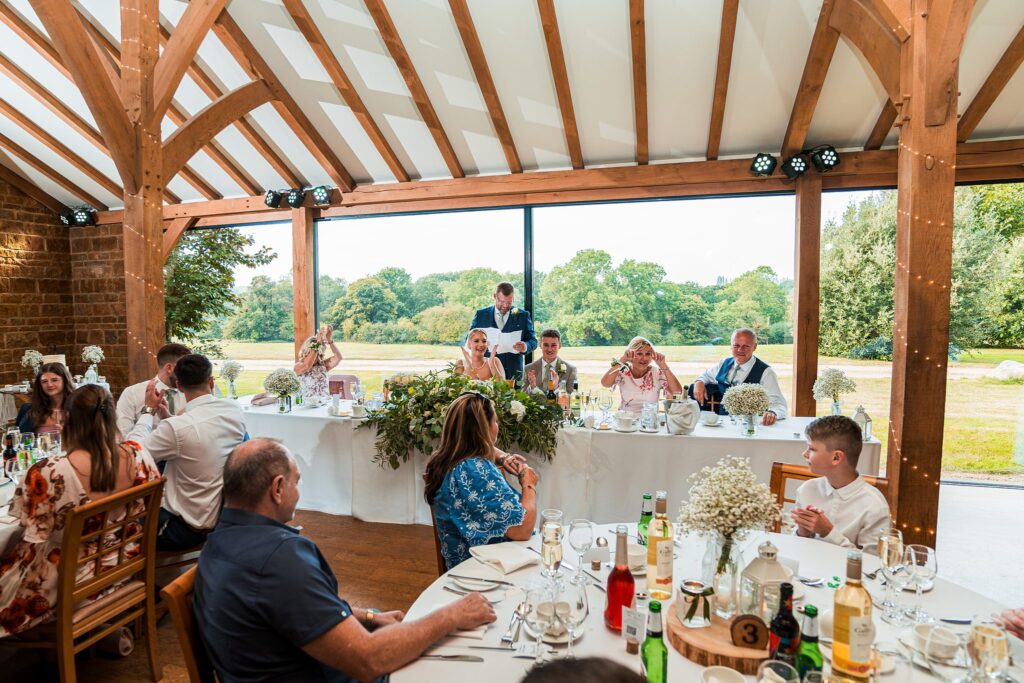 Wedding guests seated at banquet with speeches.