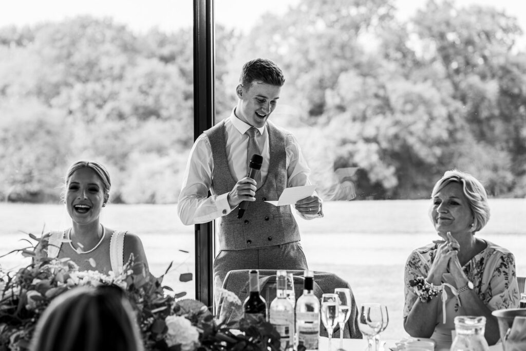 Man giving speech at a wedding reception.
