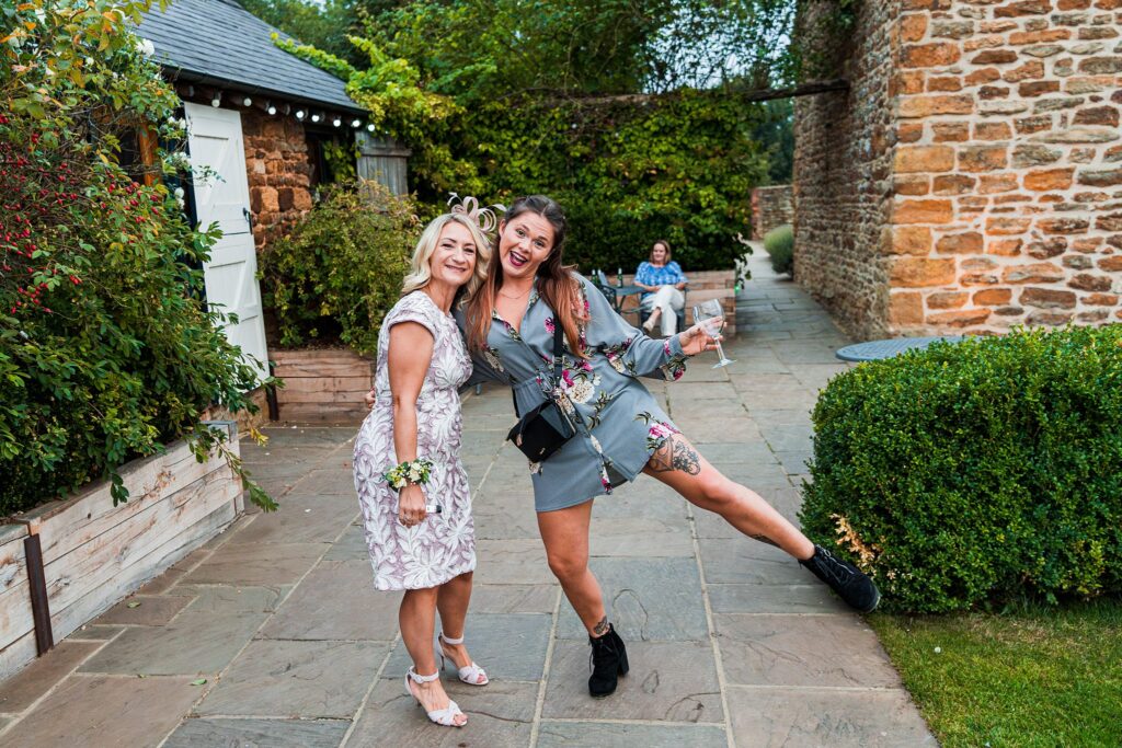 Two women posing happily at outdoor event.
