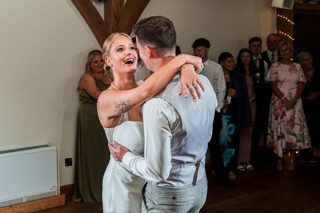 Bride and groom dancing at wedding reception.