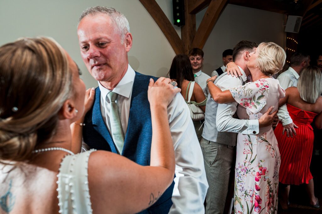 Couples dancing closely at festive wedding reception.