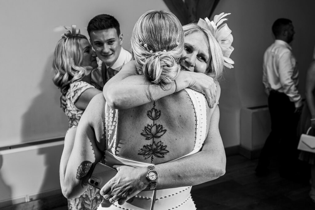 Women hugging at a wedding celebration