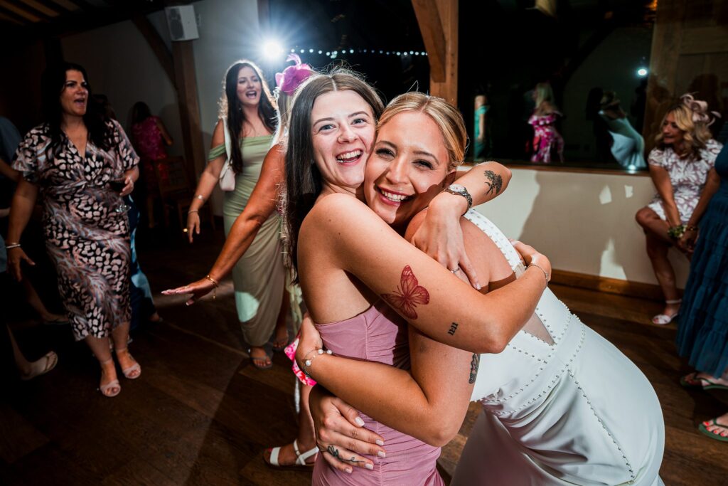 Joyful friends dancing at a celebration party.