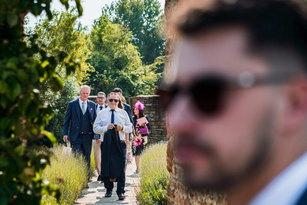 Group of people walking outdoors in formal attire.